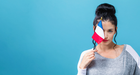 Young woman with a Italian flag on a blue backgroundの写真素材