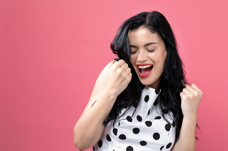 Successful young woman on a solid backgroundの写真素材