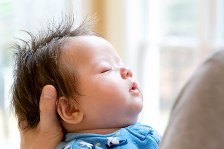 Newborn baby boy being held by his fatherの写真素材