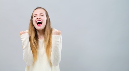 Successful young woman on a gray backgroundの写真素材
