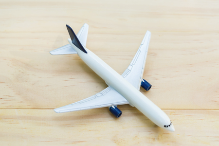 A toy airplane on wooden table - overhead viewの写真素材
