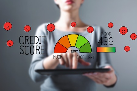 Poor credit score with business woman using a tablet computerの写真素材