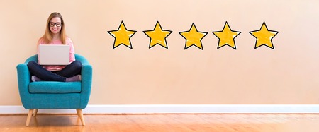 Five star rating with young woman using her laptop in a chair