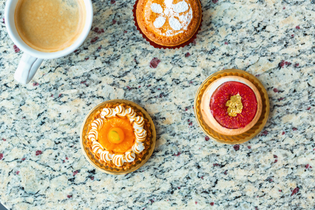 Handcrafted gourmet fruit tarts and pastries with coffeeの写真素材
