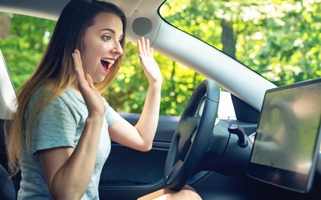 Young woman in a self-driving autonomous electric car