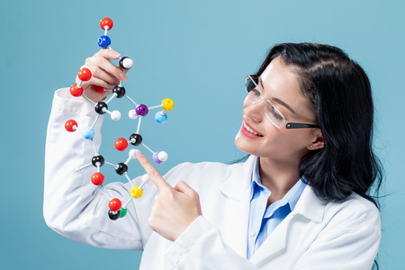 Female scientist researcher with molecule model on a blue backgroundの写真素材
