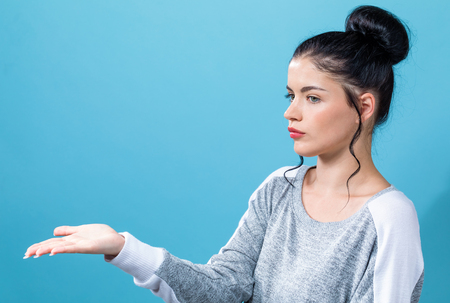 Young woman with a displaying hand gestureの写真素材