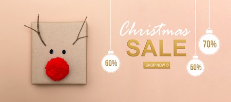 Christmas sale message with a red nose reindeer gift boxの写真素材