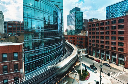 An elevated train curving through Downtown Chicagoの写真素材