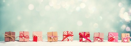 Collection of Christmas gift boxes in a snow covered landscape