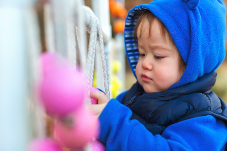 Toddler boy playing outside on an autumn day