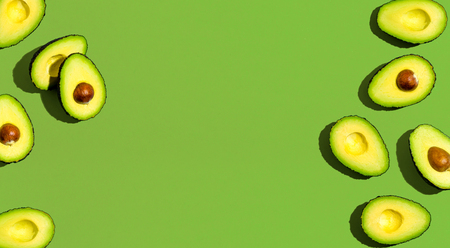 Fresh avocado pattern on a green background flat layの写真素材