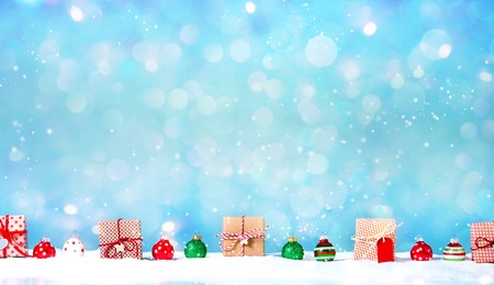 Collection of Christmas gift boxes in a snow covered landscape