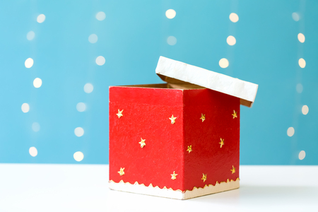 Christmas gift box on a shiny light blue backgroundの写真素材
