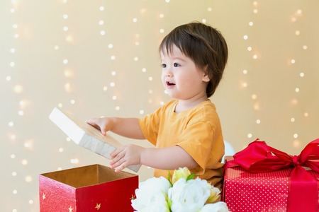 Happy toddler boy with Christmas present boxesの写真素材