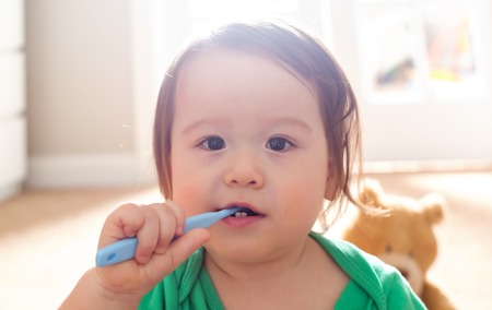 Toddler boy brushing his teeth with a toothbrushの写真素材