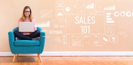 Sales 101 with young woman using her laptop in a chairの写真素材