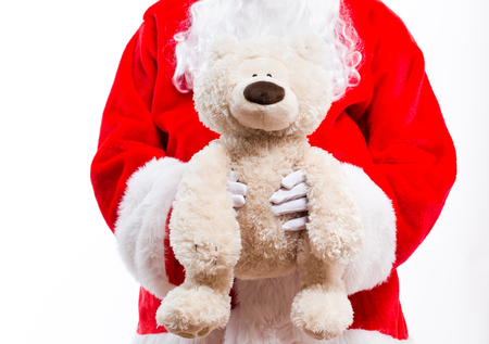 Santa holding a teddy bear isolated on white backgroundの写真素材