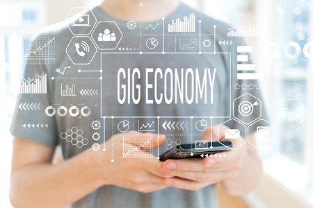 Gig economy with young man using a smartphoneの写真素材