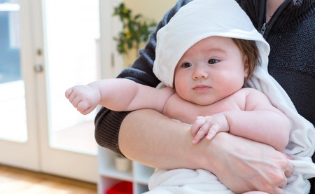 Little baby boy being cared for by his parents