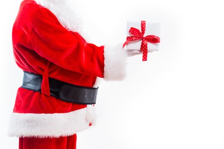 Santa holding a Christmas gift isolated on white backgroundの写真素材