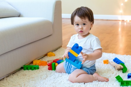 Little toddler boy playing with his toysの写真素材