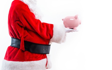 Santa holding a piggy bank isolated on white backgroundの写真素材