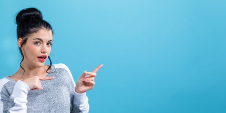 Young woman with a displaying hand gestureの写真素材