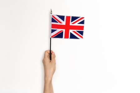 Person holding the UK Flag on a white backgroundの写真素材