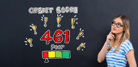 Poor credit score theme with young woman in front of a blackboardの写真素材