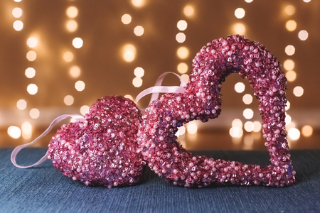 Heart shaped decorations over abstract light backgroundの写真素材