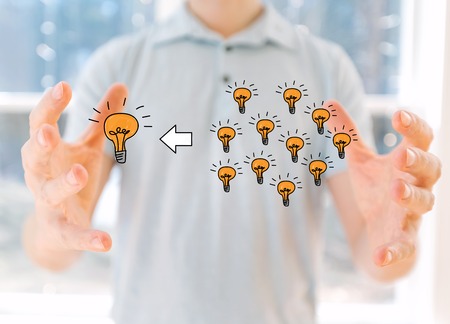 Many small ideas into one big idea with young man holding his hands