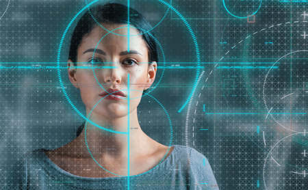 Portrait of a young woman with biometric technology themeの写真素材