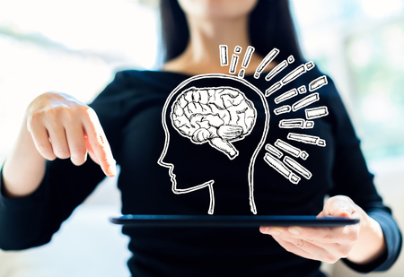 Brain illustration with woman using her tablet