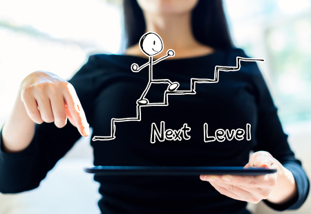 Next level concept with woman using her tabletの写真素材