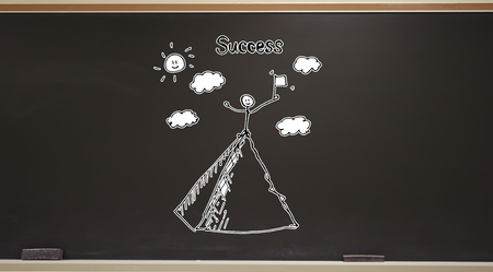 Standing on the top of a mountain on a blackboard with erasersの写真素材