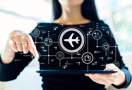 Airplane travel theme with woman using her tabletの写真素材