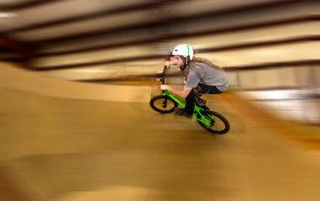 Man jumping and riding on a BMX bicycle at an extreme sports parkの写真素材