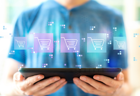Online shopping theme with young man using a tablet computerの写真素材