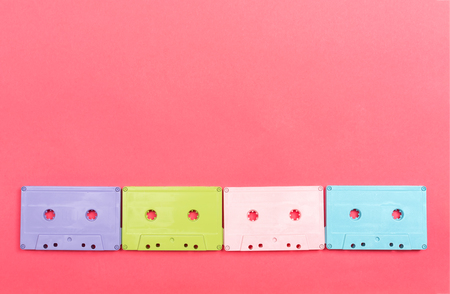 Retro cassette tape on a pink paper background