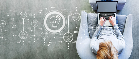 LiFi theme with man using a laptop in a modern gray chair LiFi theme with man using a laptop in a modern gray chair