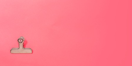 Paper clips office supply stationery on a pink paper backgroundの写真素材