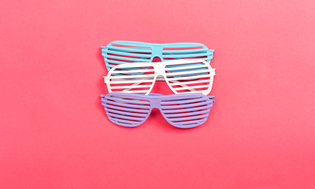 Shutter shade party glasses on a pink paper backgroundの写真素材
