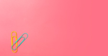 Paper clips office supply stationery on a pink paper background