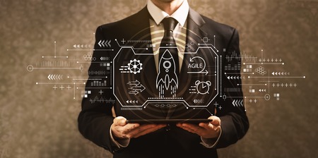 Agile concept with businessman holding a tablet computerの写真素材