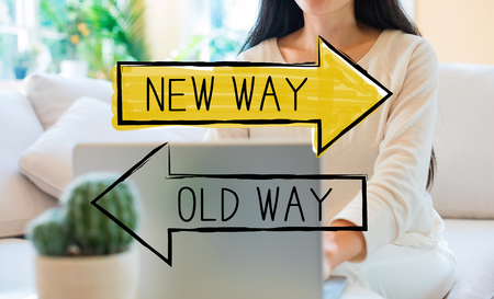 Old way or new way with woman using her laptop in her home officeの写真素材