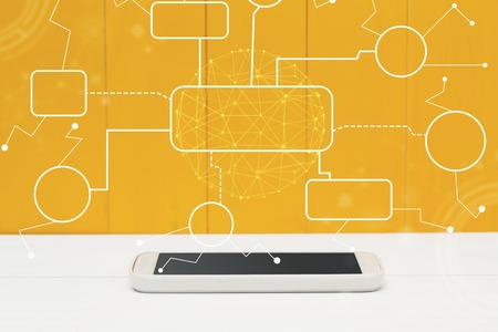 Flowchart with smartphone on yellow wooden background