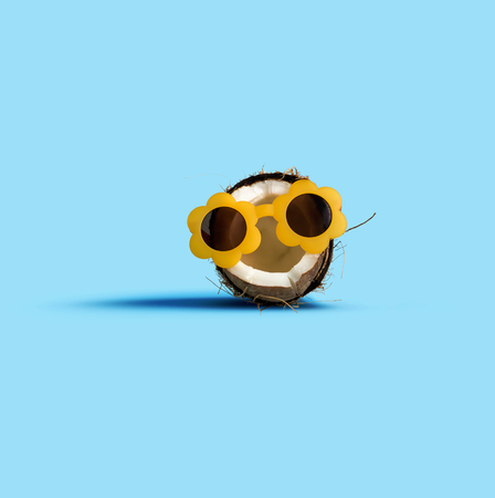 Coconut waring sunglasses on a solid backgroundの写真素材