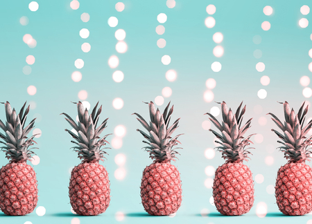 Many pineapples on a shiny light backgroundの写真素材