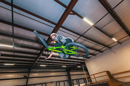 Man jumping and riding on a BMX bicycle at an extreme sports parkの写真素材